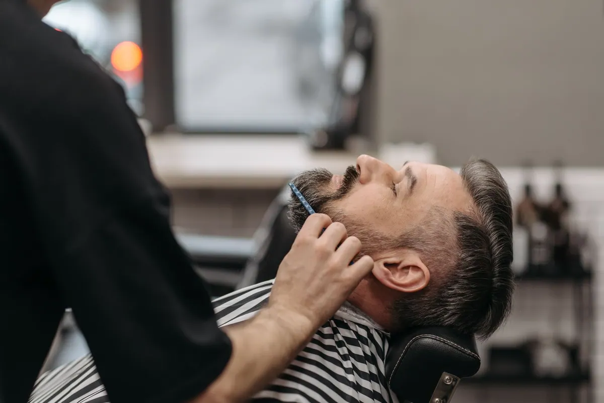 Barbier rasant un client Barbier rasant un client